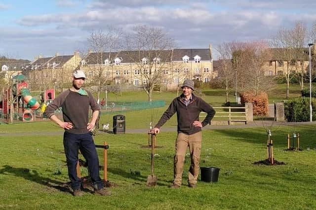 Alnwick town councillors Peter Edge and Martin Swinbank help plant fruit trees in Swansfield Park.