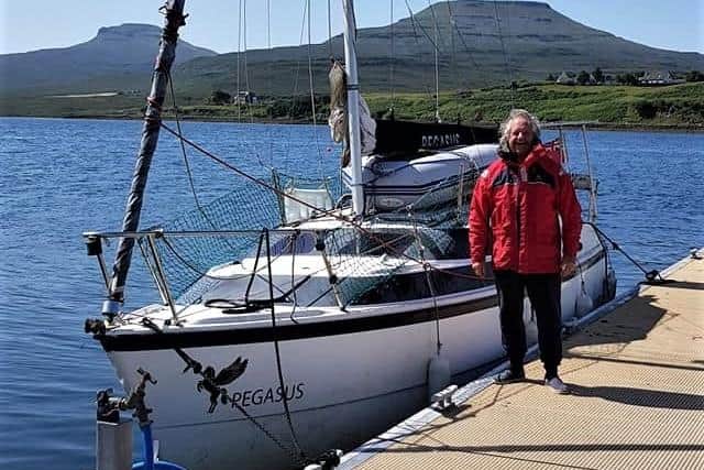 Richard Kerswell pictured next to his yacht, Pegasus, earlier in his trip.