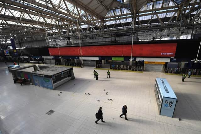 Police Office and National Rail Staff are seen at an empty Waterloo Station in London (Photo: Alex Davidson/Getty Images)