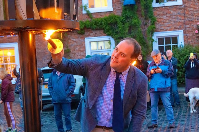 Local councillor Guy Renner-Thompson lights the Belford beacon.