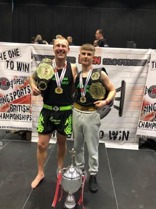 Adam and Archie with their medals and belts.