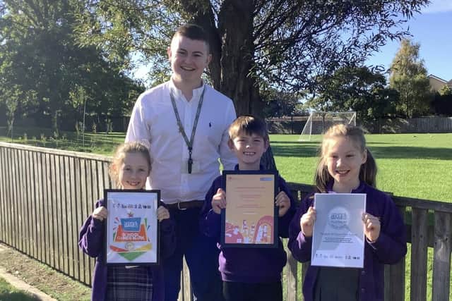 PE lead Jack O'Halloran with year four pupils and the platinum award.