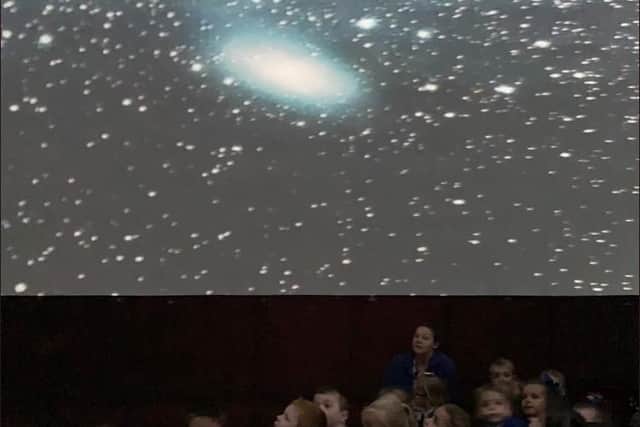 Pupils having fun inside the planetarium.