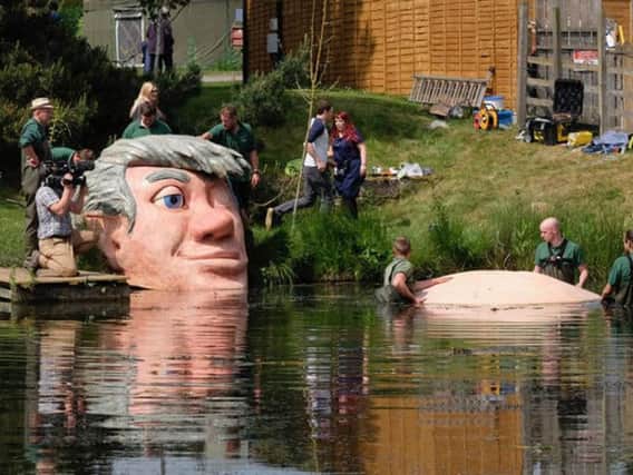 The giant's belly is moved into place in The Alnwick Garden pond. Picture by Margaret Whittaker