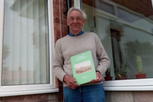 Brian Harle with a copy of the Morpeth, A Social History book.