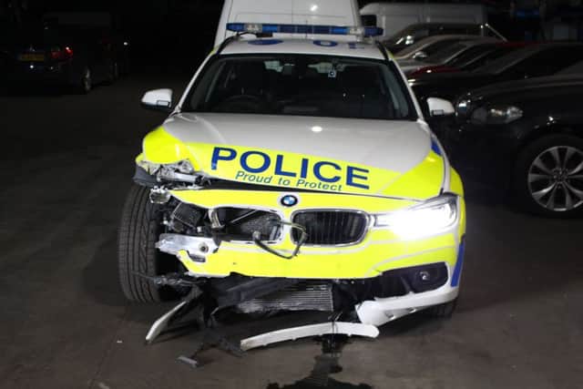 The damaged police car.