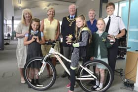 Julia Aston from Amble Development Trust, runner-up Kelsie Ramsay, Katie Spurr from Spurreli's who donated the bike, Amble Mayor Craig Weir, winner Lily Henderson, PCSO Darin Fawcett, runner-up Jasmine Conway and Chief Inspector Helena Barron, at the  Amble and Warkworth Yoing Citizen Award presentation ceremony. Picture by Jane Coltman