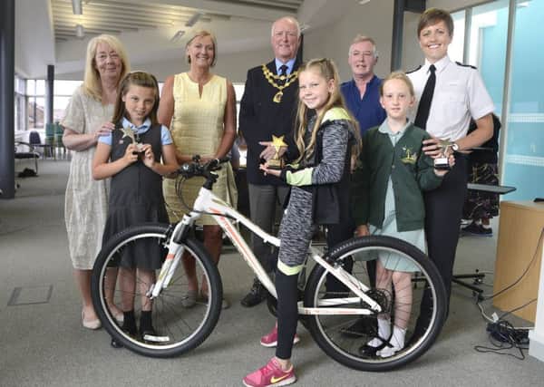 Julia Aston from Amble Development Trust, runner-up Kelsie Ramsay, Katie Spurr from Spurreli's who donated the bike, Amble Mayor Craig Weir, winner Lily Henderson, PCSO Darin Fawcett, runner-up Jasmine Conway and Chief Inspector Helena Barron, at the  Amble and Warkworth Yoing Citizen Award presentation ceremony. Picture by Jane Coltman