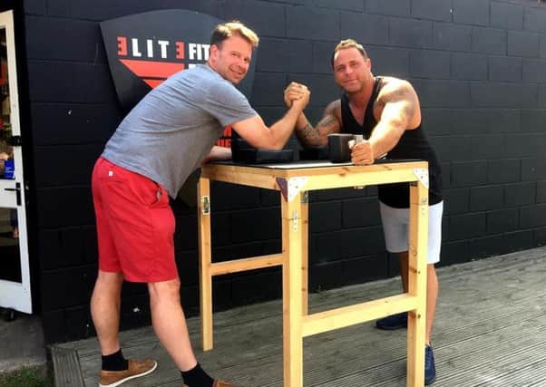 Jonathan Park and Olly Dial with one of the arm-wrestling tables.