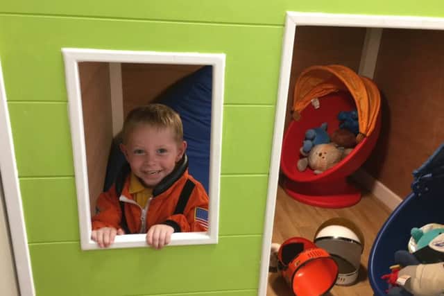 One youngster enjoys dressing up as a NASA spaceman in one of the discovery dens at The Family Hub.