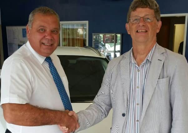 Philip Angier and Derek Oetting shake hands to mark the sponsorship deal.