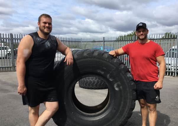 James Crowther with his trainer, Daniel Frazier and the monster tyres at FSI gym.
