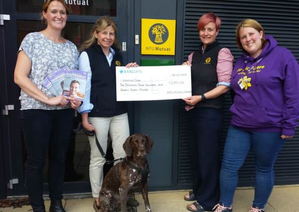 Miriam, Jane, Tania and Lexi the dog, handing over the cheque to HospiceCare fund-raiser, Emma Arthur.