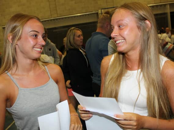 Identical twins Scarlett and Tabby Carling who received almost identical GCSE results.
