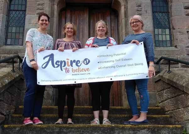 Rachel Hepworth, Helen Deane-Hall, Tracey Young and Cindy Fairbairn with the Aspire to Believe North East Ltd banner outside the Glendale Hall.