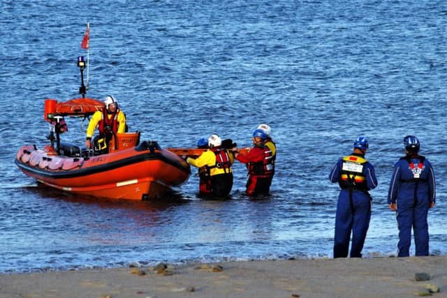 Coastguard and lifeboat teams working together.