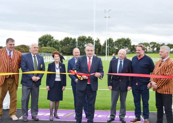 Tynemouth MP Alan Campbell cuts the ribbon to open the new artificial pitch with, left to right, Lawrence Fletcher (Whitley Bay Rockcliff RFC), Trevor Morrison (president, Northumberland Rugby Union), Mayor Norma Redfearn, Steve Grainger (RFU), Danny Hodgson (RFU council member), Dave Reed (RFU), and Scott Carruthers (president, Whitley Bay Rockcliff RFC)).