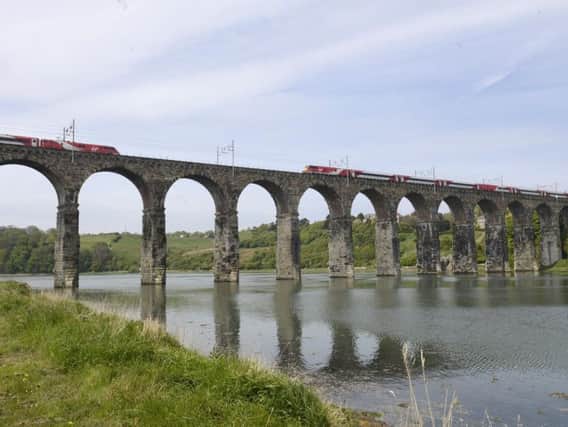 Trains cross the Royal Border Bridge at Berwick.