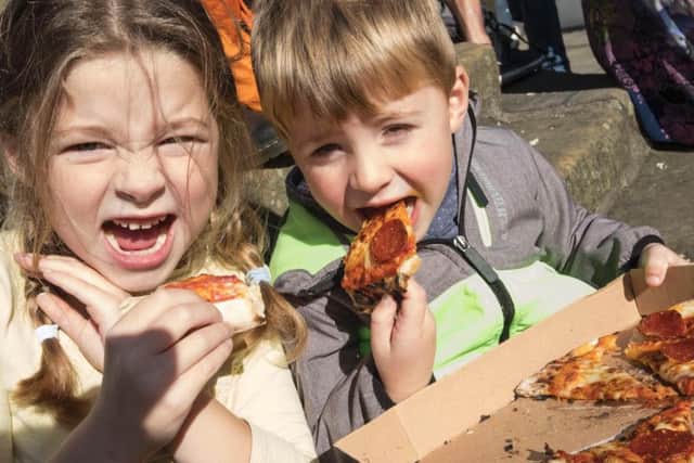 Tucking in - youngsters enjoy a taste of the festival. Picture by Jane Coltman