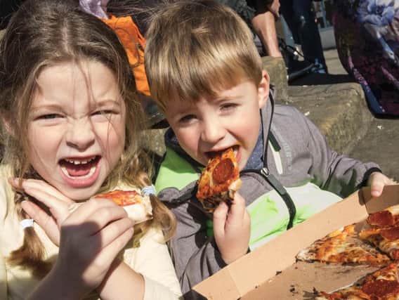 Tucking in - youngsters enjoy a taste of the festival. Picture by Jane Coltman