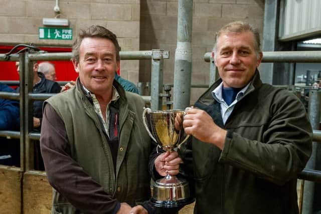 Vince Milburn, left, presented with the trophy by judge Mark Ross.