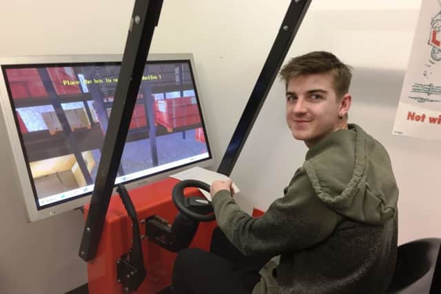 One trainee tries his hand on the forklift simulator at the Barnardos Employment Training and Skills (ETS) North.