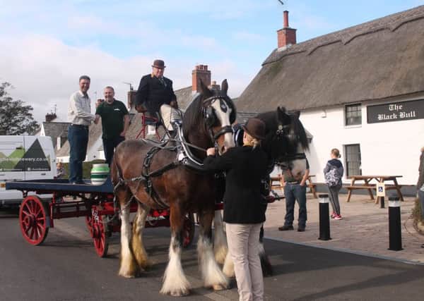 Anna Cockburn, standing in front of the horses, John Owen, seated, Black Bull manager Iain Dickson, standing on dray on the left, and Cheviot Brewery sales director Peter Nash, right.