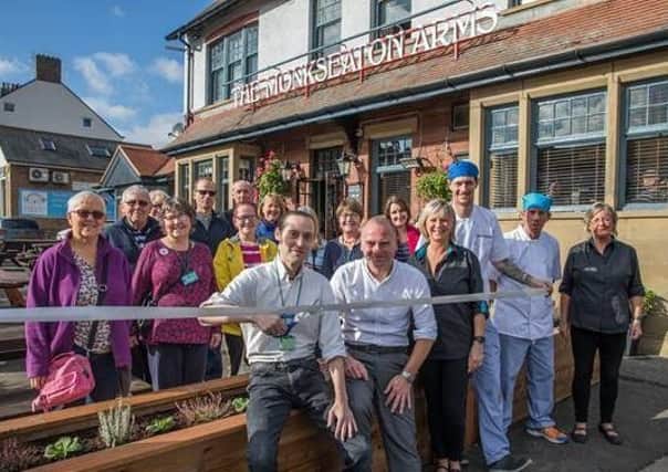 Matt Morrison, chairman of Whitley Bay Community Allotment and Gardens charity, with Leigh Dryden, general manager of the Monkseaton Arms (right), and pub staff.