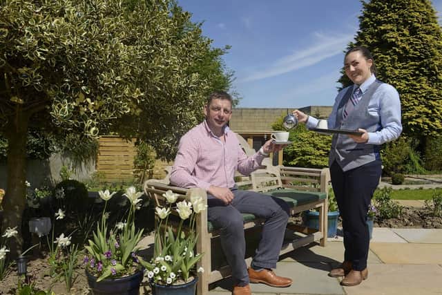 Hotel manager Mick Holland and Katie Thompson in the garden at The Cookie Jar in Alnwick. Picture by Jane Coltman