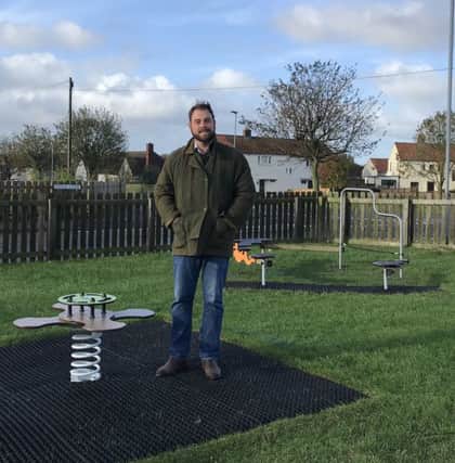 Coun Guy Renner-Thompson, county councillor for Bamburgh ward, with the new equipment installed in the James Street play park in Seahouses.