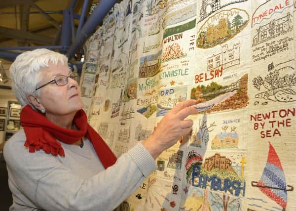 Baliffgate Museum volunteer Sheila Starks looks at a Northumberland WI banner which is part of the new exhibition. Picture by Jane Coltman