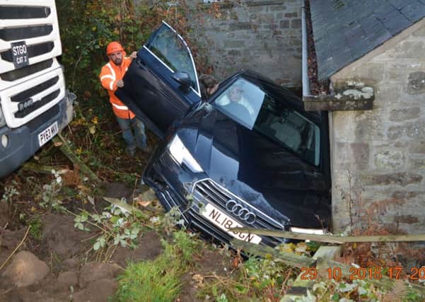Julia Grieveson receives help after her car was shunted off the road. Picture by Barry Grieveson
