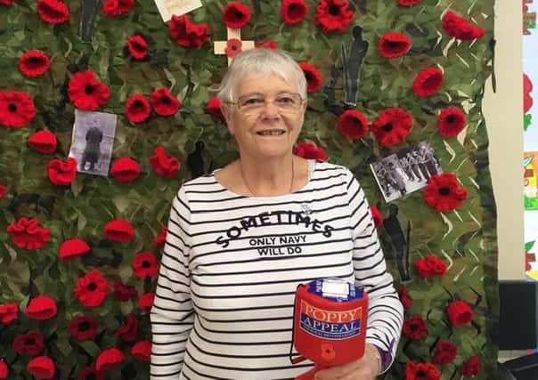 Poppy seller Catherine Davies in front of the display.