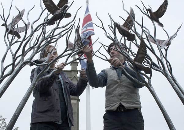 Blacksmith Stephen Lunn and his daughter Ashlee Donaldson put the finishing touches to the new Amble peace sculpture. Picture by The Ambler