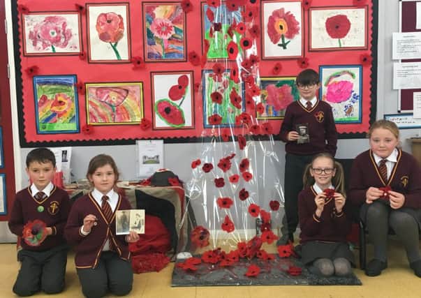 Whittingham Primary School pupils are pictured with artwork about the important symbol of poppies.