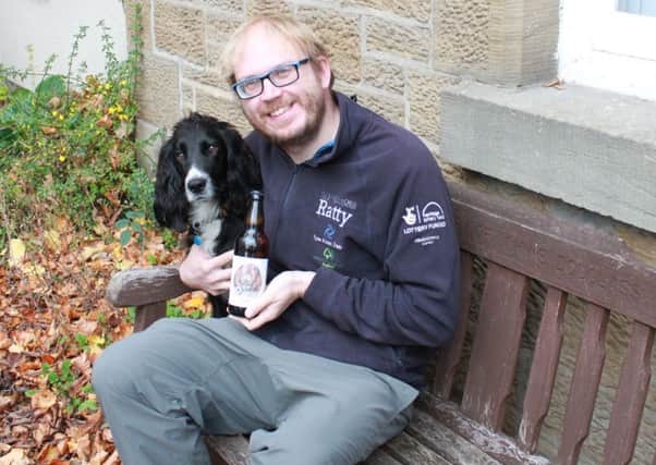 Restoring Ratty project officer Graham Holyoak and his dog Yogi with a bottle of Ratty ale. Picture by Fiona Dryden