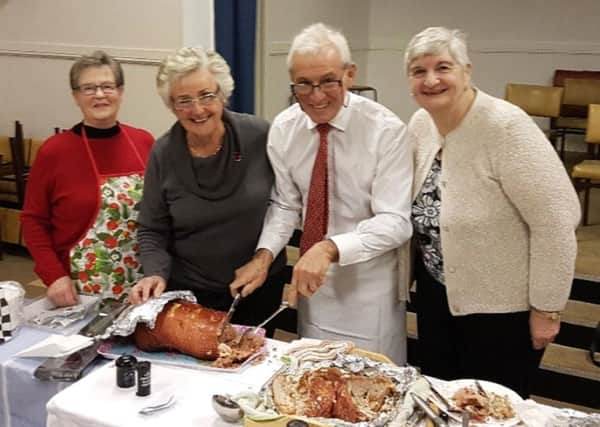 County councillor Trevor Thorne carving the turkey, ably assisted by Sylvia Willcox, Isobel Watson and Elisabeth Haddow.