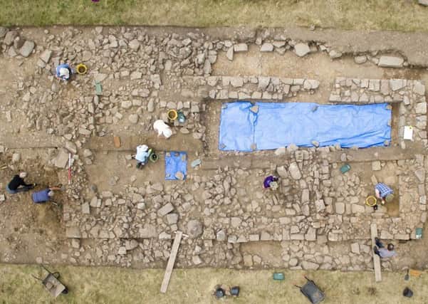 Volunteers working on the exposed remains of a medieval farmhouse at Linbrig, near Alwinton.