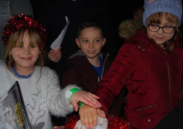 Poppy Wood, Daniel Hall and Kayden Ruler switch on the Christmas lights in Seghill.