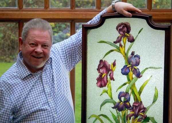 Neil Wilton with one of the pieces from his cloisonne collection.