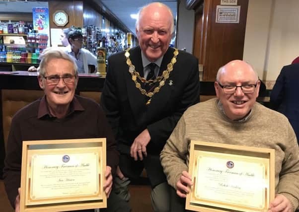 Amble Mayor Craig Weir presents certificates to former town councillors Ian Hinson and Robert Arckless after announcing their appointment as the first Honorary Freemen of Amble at the Mayor's Christmas Reception at the Radcliffe Club.