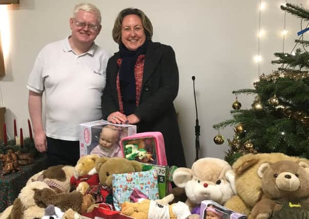 Anne-Marie Trevelyan with Lt Andrew Manley and the toys donated by constituents.