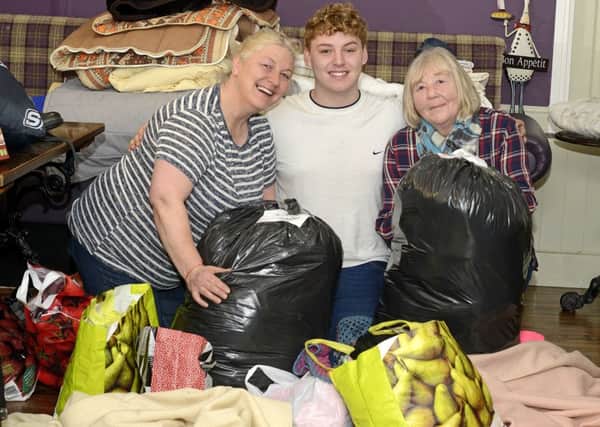 Jackie McDougall, Alex McDougall and Margaret Brennan with some of the items donated. Picture by Jane Coltman