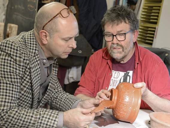 Marc Allum, left, and Graham Taylor piece together the Samian ware property in advance of a replica being made. Picture by Jane Coltman