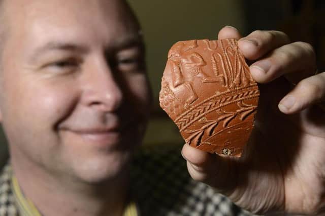 Marc Allum with a piece of the Samian ware pottery that was dug up in his back garden in Chippenham, Wiltshire. Picture by Jane Coltman