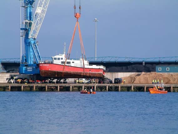 The catamaran Wind Transfer is lifted from the water at Blyth.