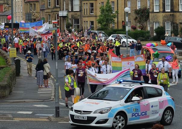 The Northumbria Police LGBT+ car and the Co-op Funeralcare rainbow hearse at the head of the march.