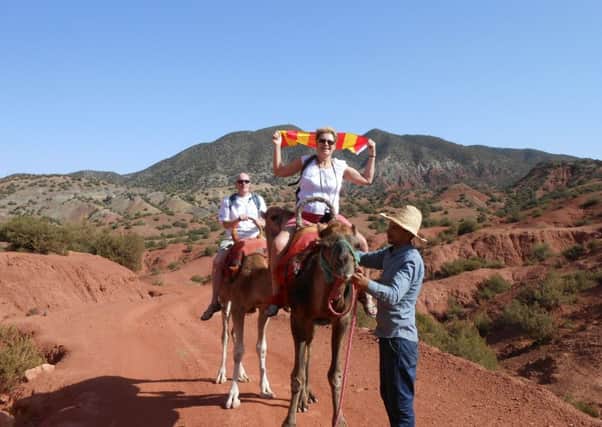 Sonja Gregory flying the Northumberland flag from the back of a camel in the Atlas Mountains of Morocco for last year's Northumberland Flag Challenge.
