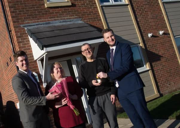 Scott Lavery and Philip World from Advance Northumberland Homes welcome new residents Anna Scott and Matthew Davies.