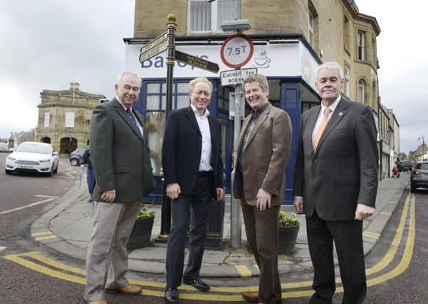 Bill Grimsey with councillors George Mavin and Gordon Castle and town council projects officer Tim Kirton during his tour of Alnwick.  Picture by Jane Coltman